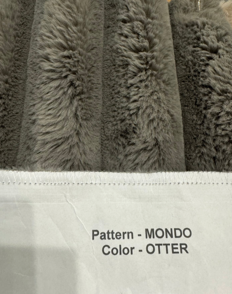 Gray textured fabric with 'Pattern - MONDO, Color - OTTER' text on a white background