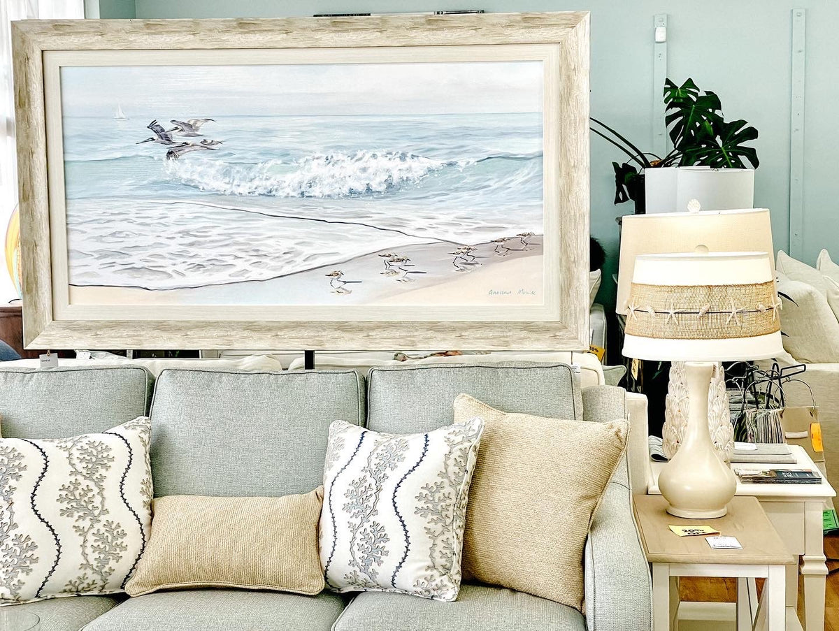 Anastasia Musick wave painting styled above a sofa at Atlantic Fine Furniture