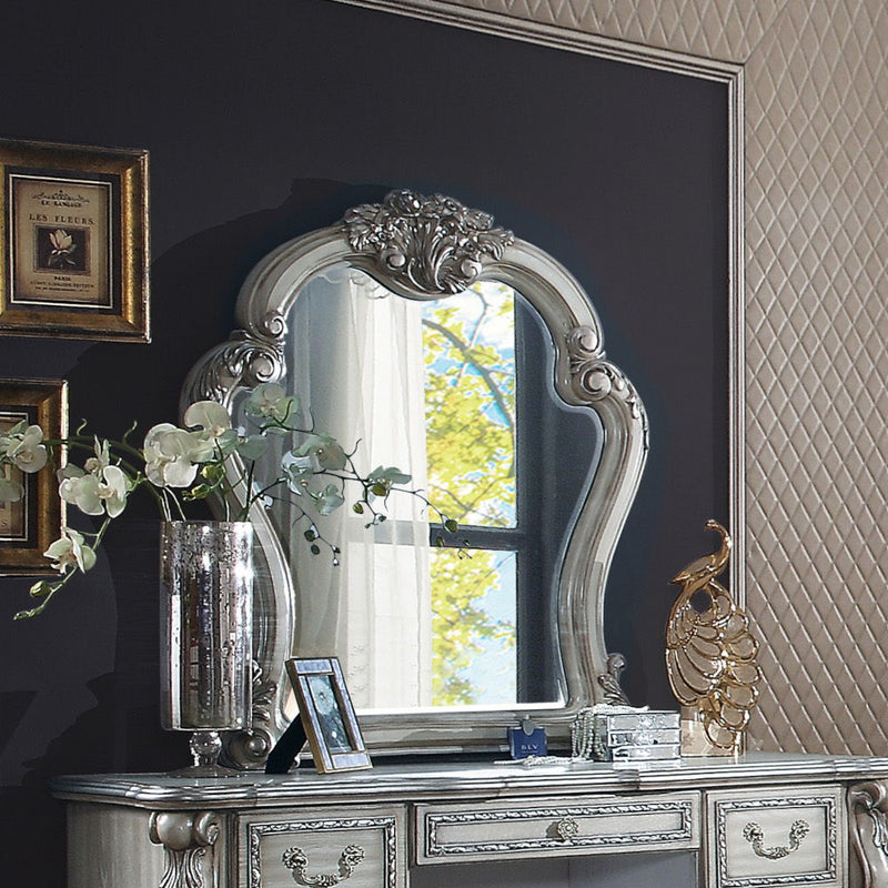 Create an elegant, classy design in your bedroom with the Dresden gold patina and bone mirror. This mirror features a beautiful scrolled frame with beveled edges. Add this mirror to any other piece from this collection to create the perfect bedroom.